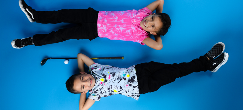 Young boy wearing Sunday Swagger golf polo
