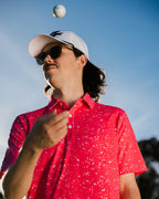 Gnarly mens golf polo. Man throwing golf ball in the air